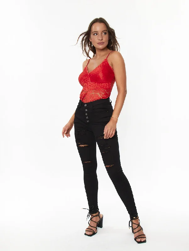 Jean skinny noir à boutons et déchirures légères Compression